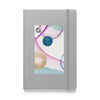 silver hardcover notebook with collage ball artwork on front