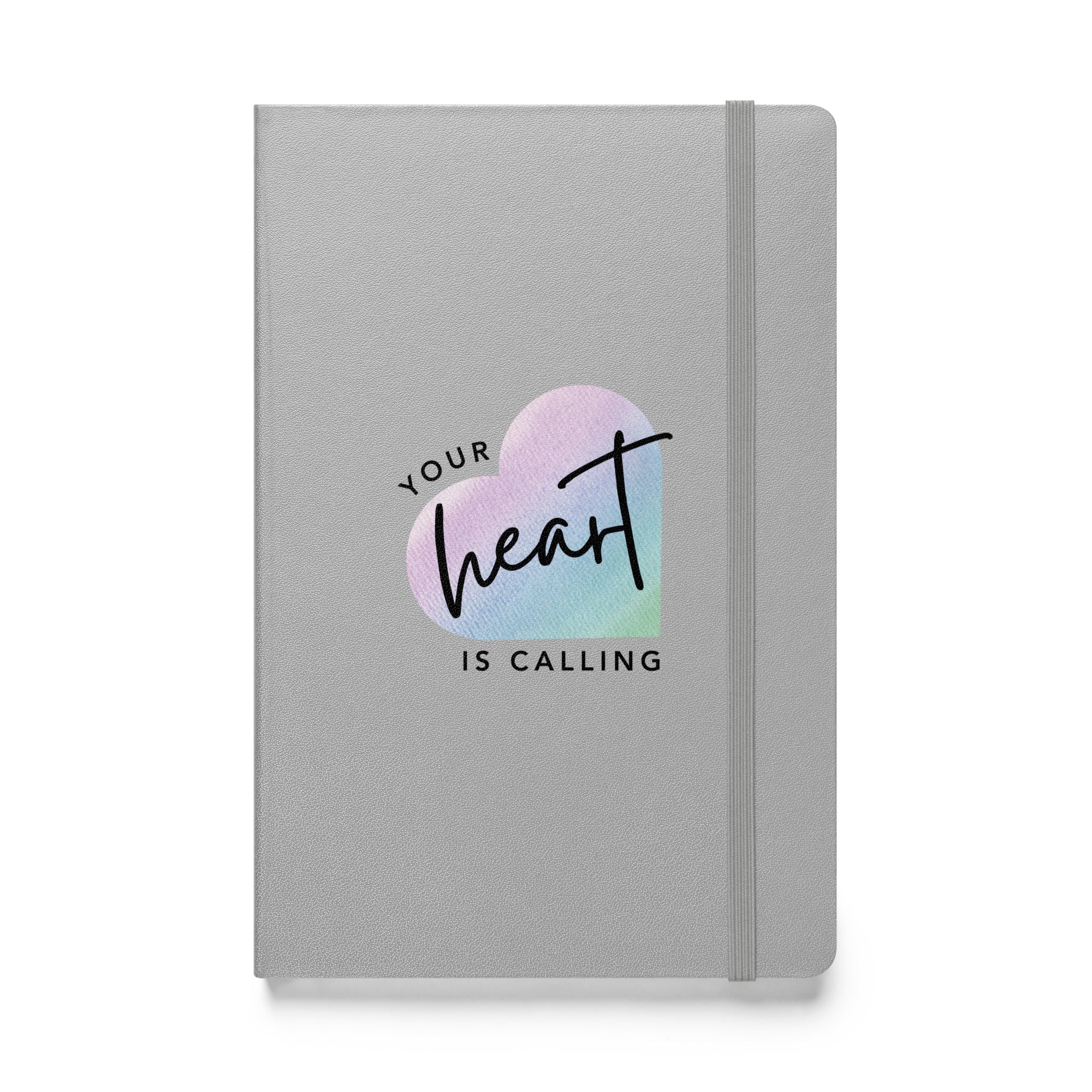 silver hardcover notebook with Your Heart Is Calling logo on front