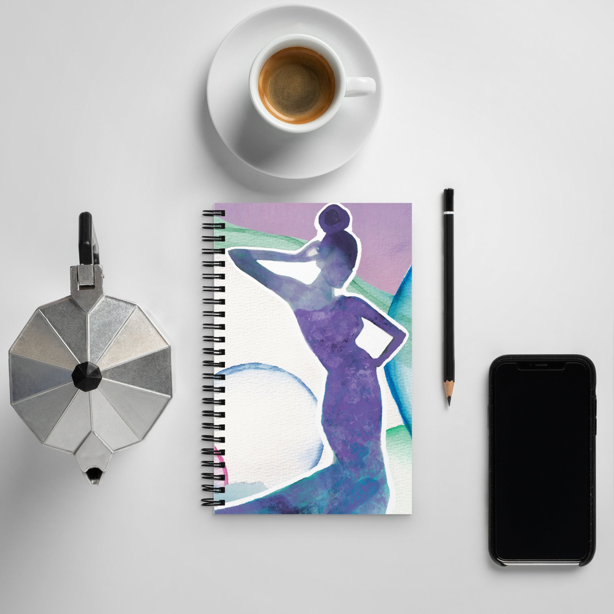 custom made spiral notebook next to coffee cup and phone