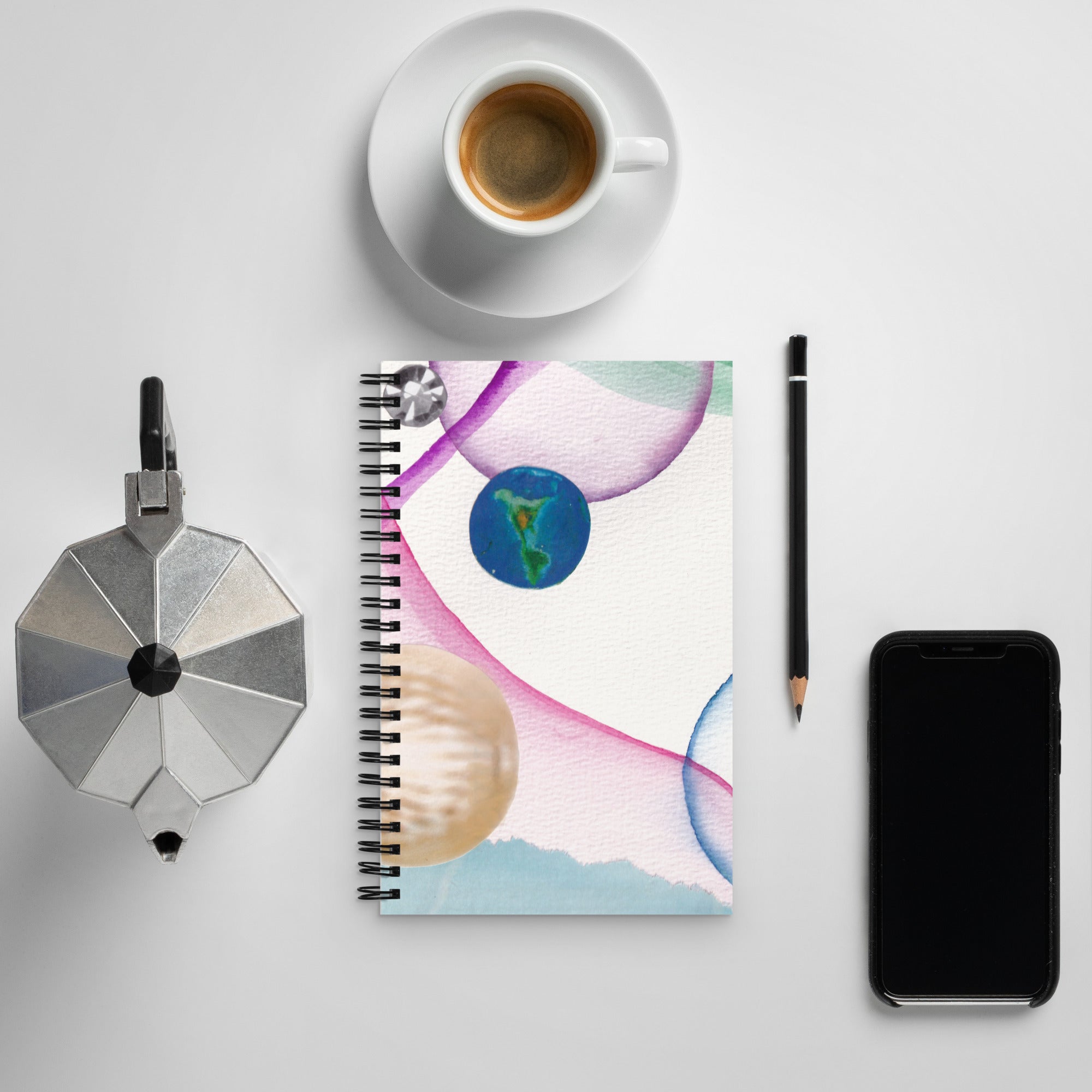 custom made spiral notebook next to coffee cup and phone